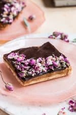 A shortbread base covered with a layer of caramel then a layer of chocolate