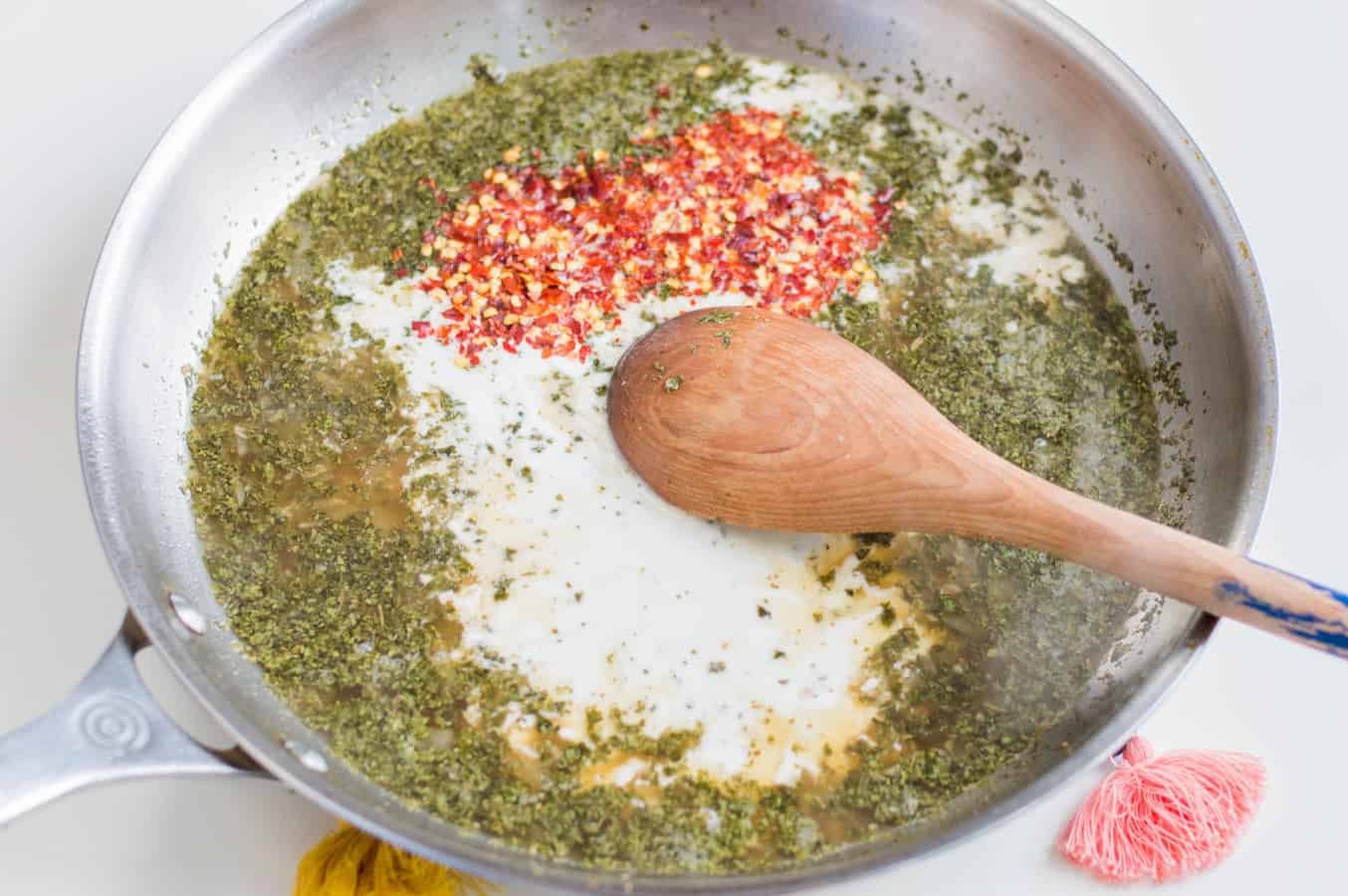 Add coconut milk and chili flakes and simmer