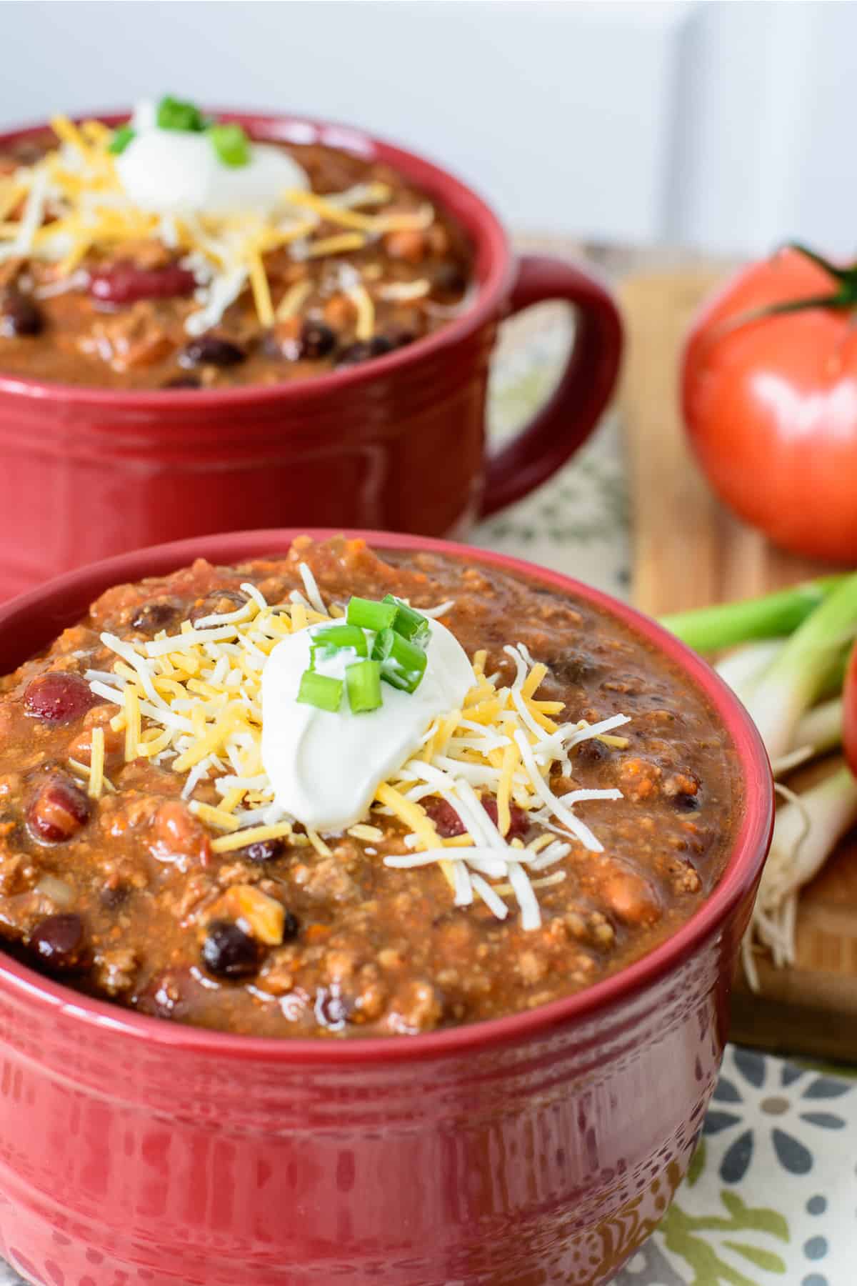 Quick and easy chili from scratch topped with sour cream, cheese and green onion.