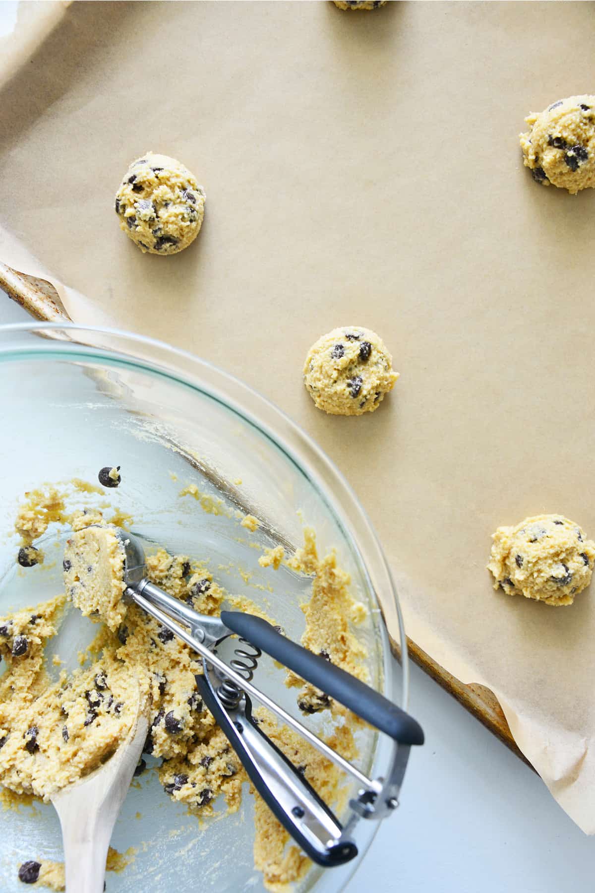 Roll it into balls, arranging them 6 to 8 per tray